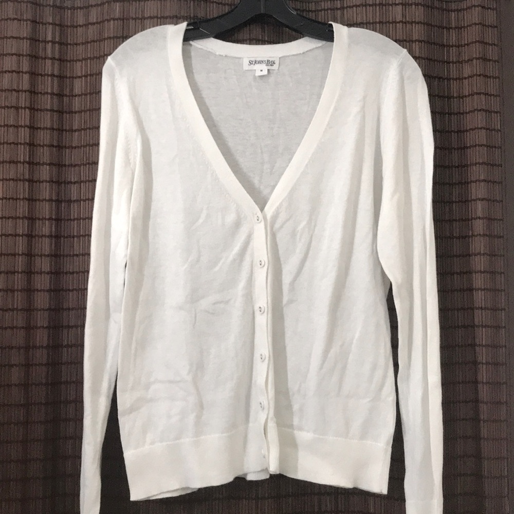 White sweater with buttons.
